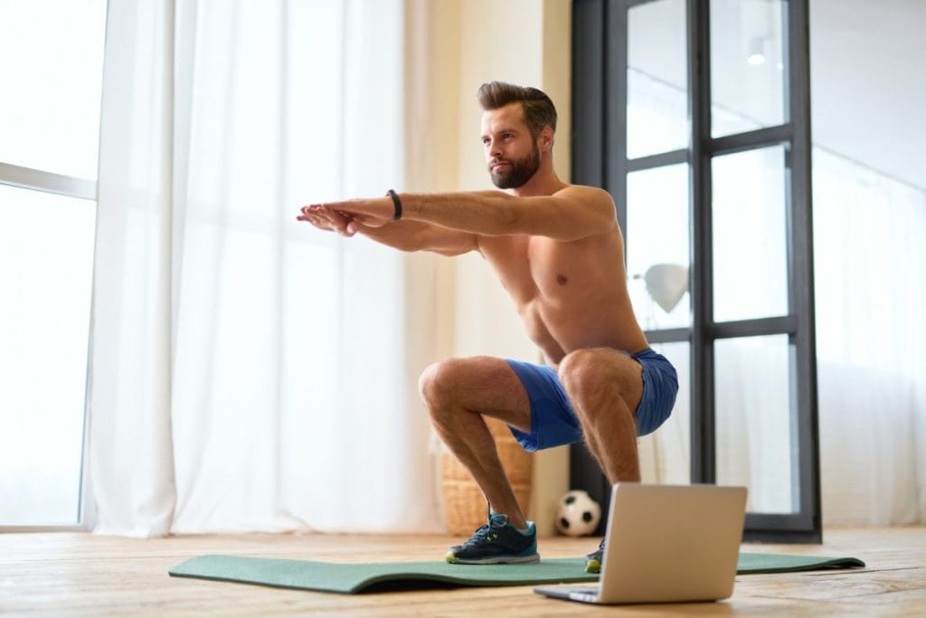 10055 man doing squats - home workout