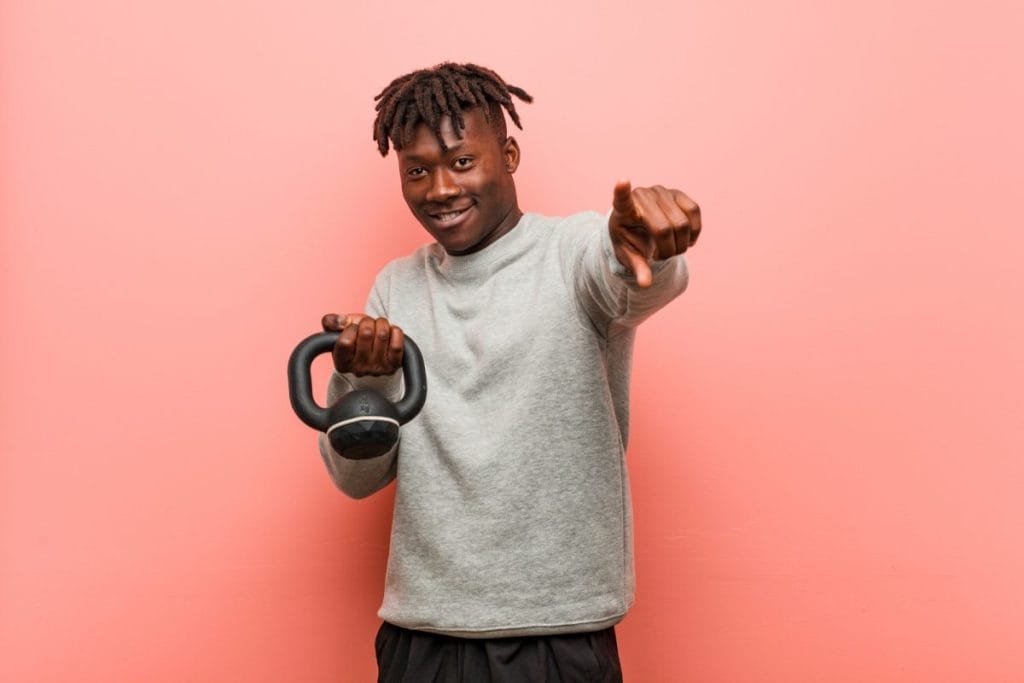 53419 man holding a kette bell - home workout