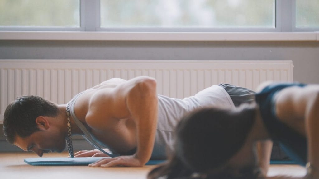 man doing push ups - At-home Renaissance periodization chest workouts