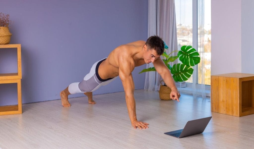 man doing push ups - At-home Renaissance periodization chest workouts