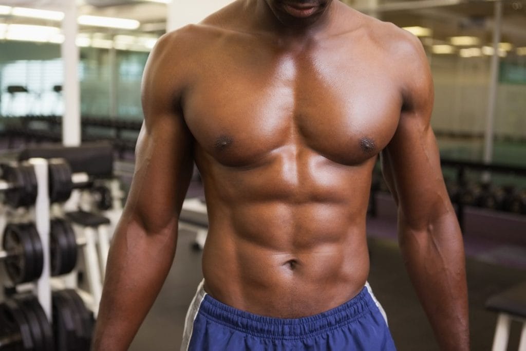 man with six pack abs - abs and chest workout at home