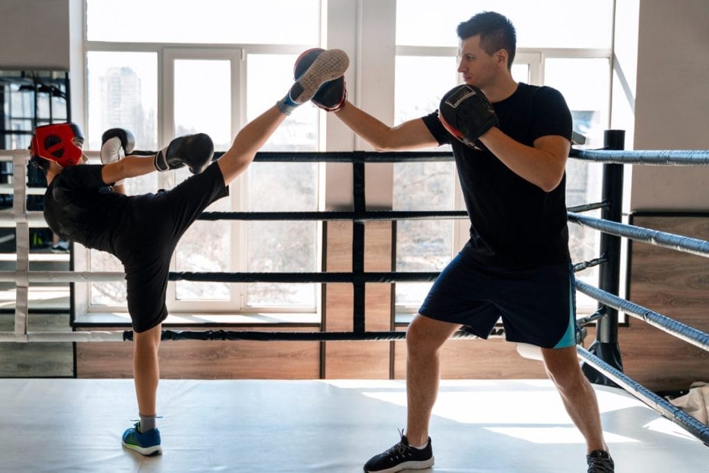 boy kicking - At-home Kickboxing Workout with a Bag