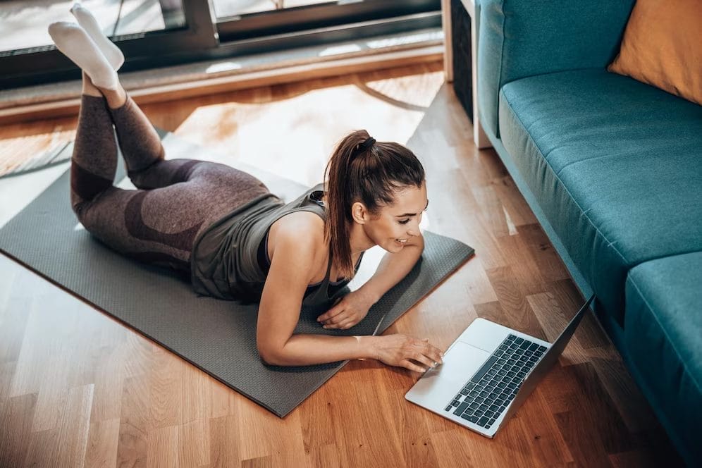 woman on a laptop - at home swimming workouts