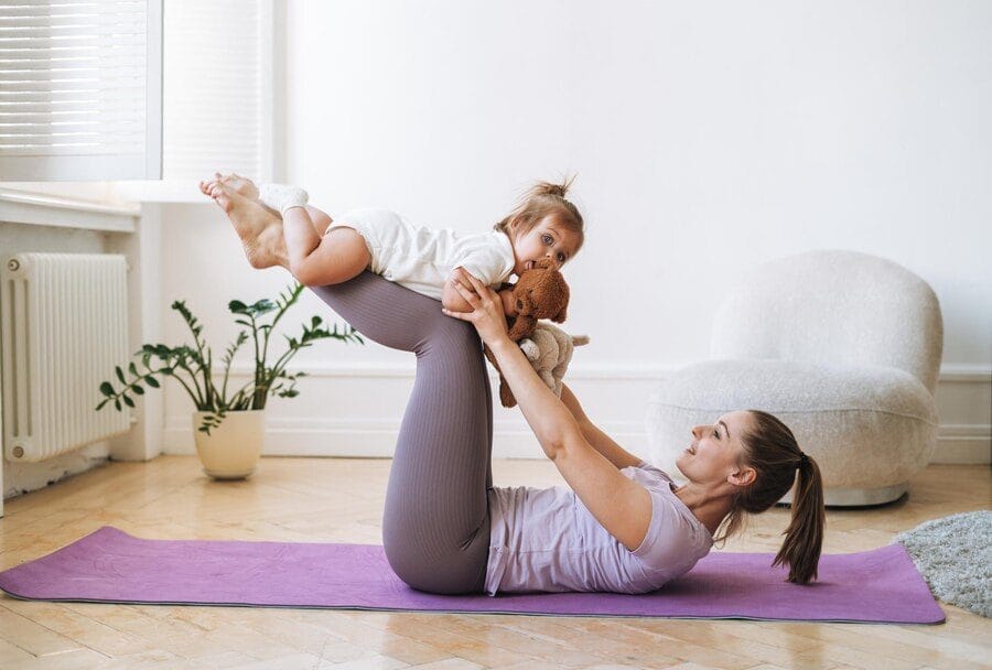 woman with a baby - at home workouts for moms