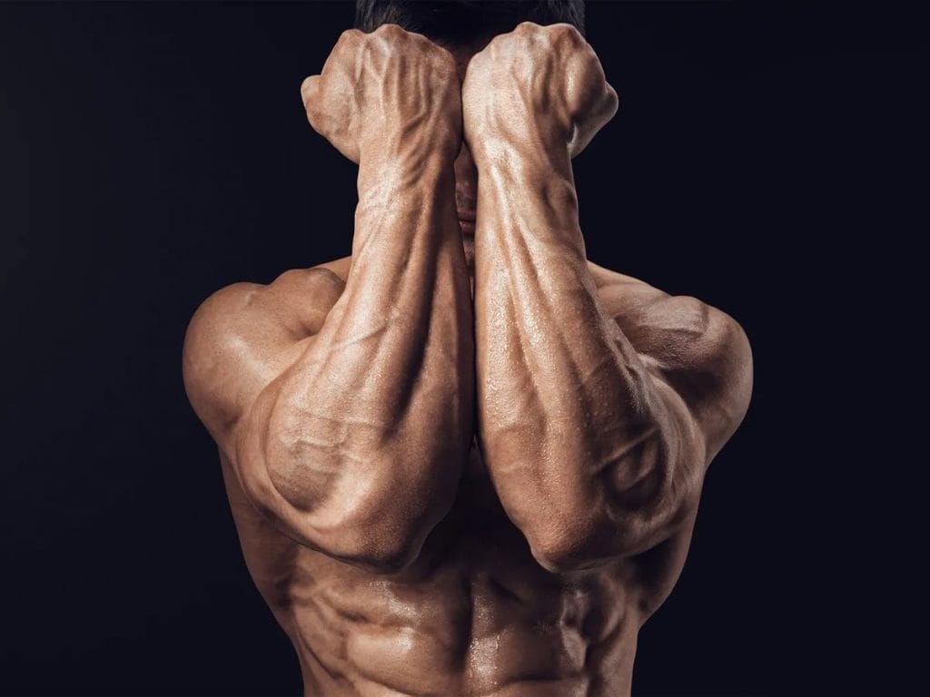 muscular man - forearm workout at home