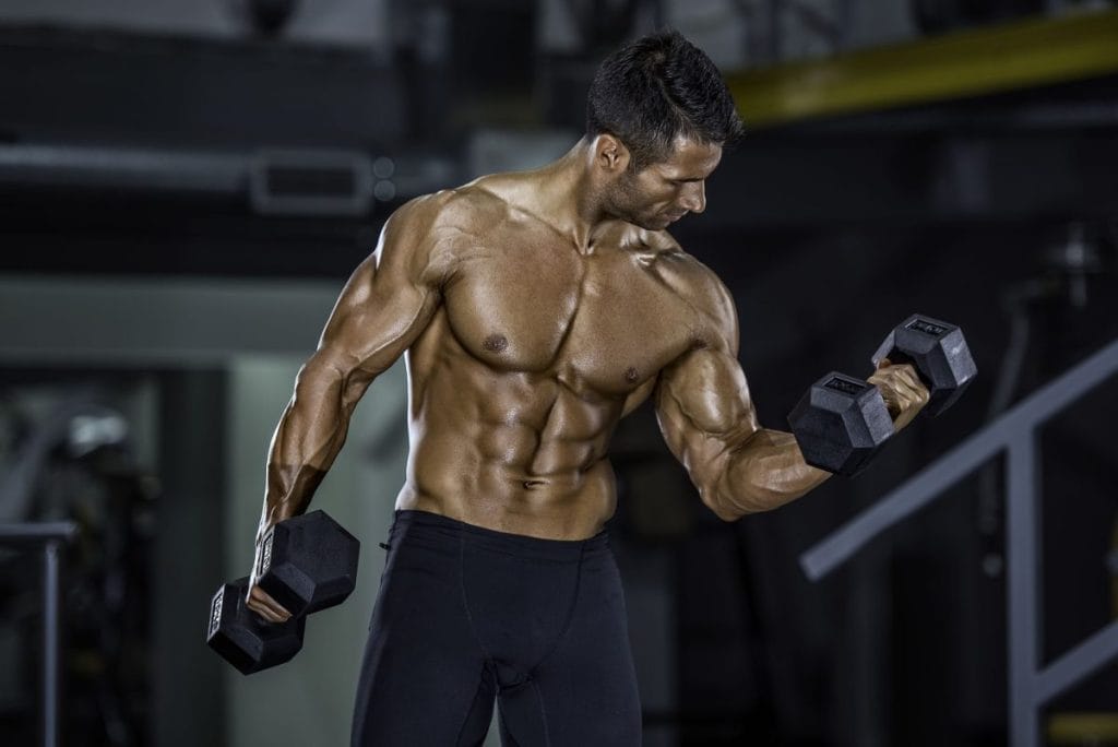 man with dumbells - forearm workout at home