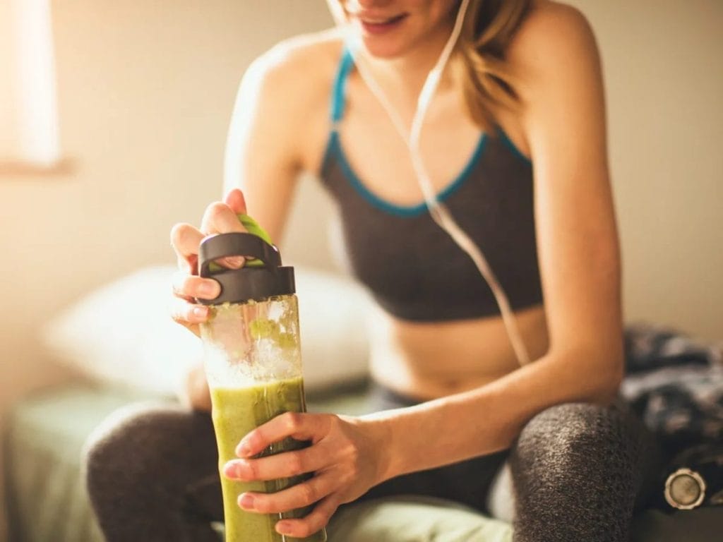 woman with a drink - How to Make Pre-workout At Home
