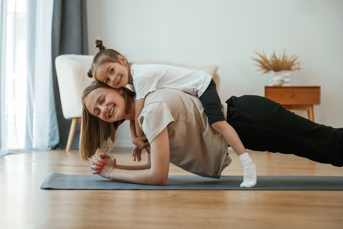 woman with a girl - at home workouts for moms